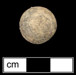 Naturally colored yellow limestone dyed with brown (manganese). Limestone marbles were being dyed in solid colors by the 1880s, but perhaps as early as the 1850s (Gartley and Carskadden 1998:101). Gartley and Carskadden also note that archaeologically-recovered examples of dyed limestone marbles are often quite faded, as is this example - click on image to see larger view.